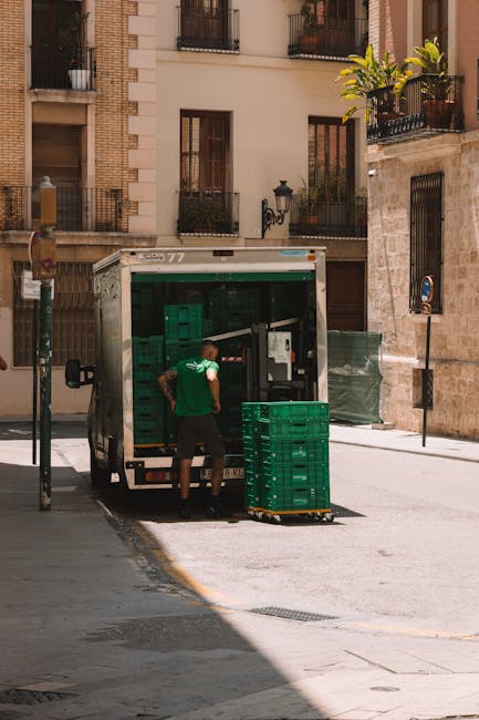 Man Loading Crates onto Delivery Truck